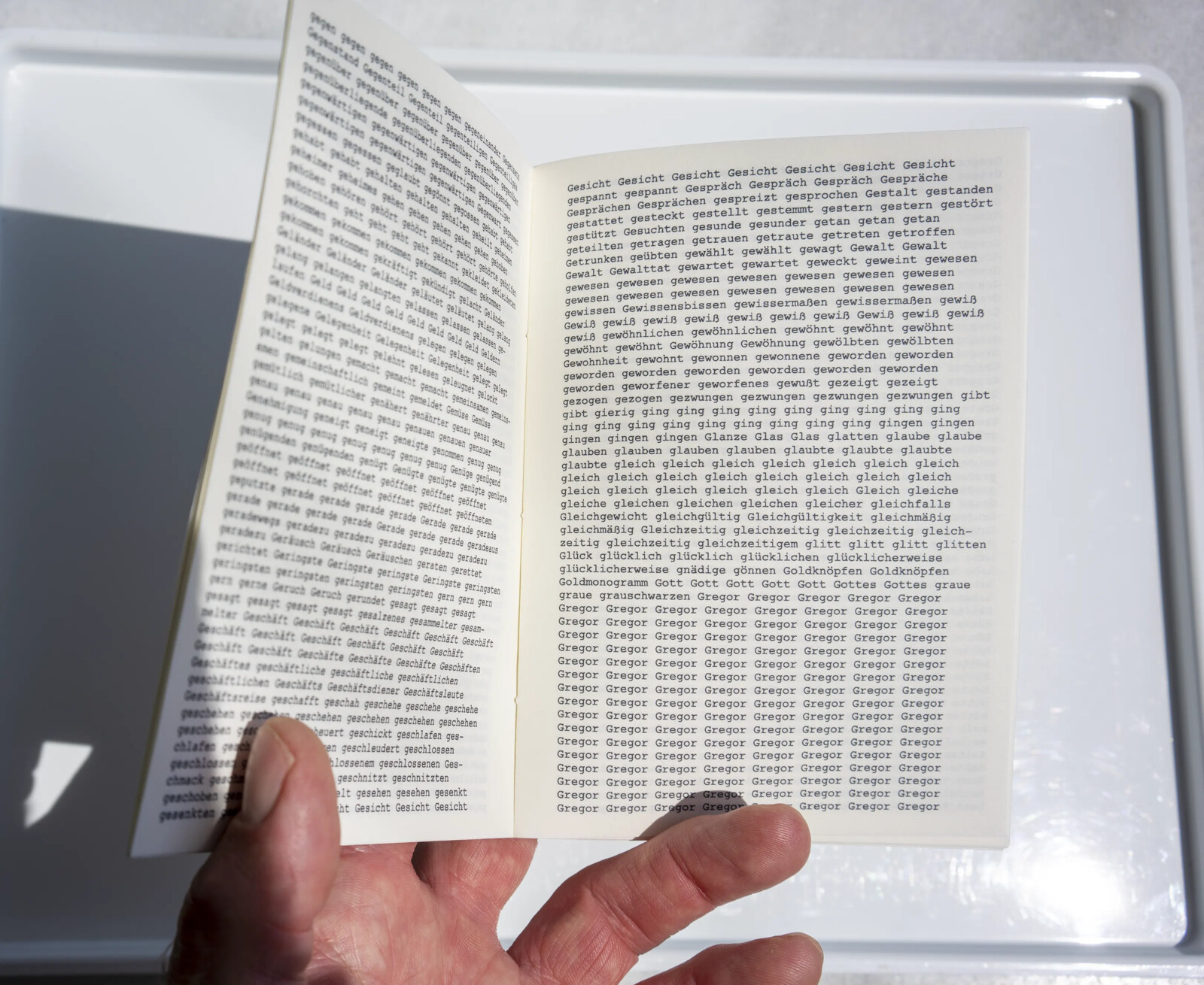 Open spread of the booklet, dense alphabetically sorted text with long repeated blocks of words